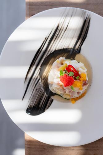 a fork sitting on a plate with food on it at Tharroe of Mykonos Boutique Hotel in Mýkonos City