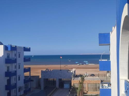 a view of the beach from a building at Luxuries Studios and apartments in Oasis Marina ,Hurghada in Hurghada