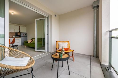 a living room with a chair and a table at Parisian Terrace - Close to Orly and RER Station C, D in Athis-Mons
