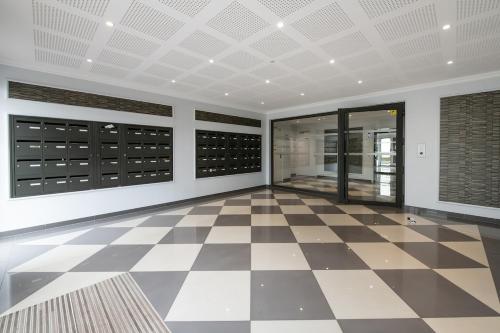 a room with a checkered floor and a wine cellar at Parisian Terrace - Close to Orly and RER Station C, D in Athis-Mons