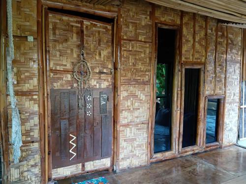 a wall of a house with a door and windows at Herbs Guest House and Restaurant near the Sea in Moalboal