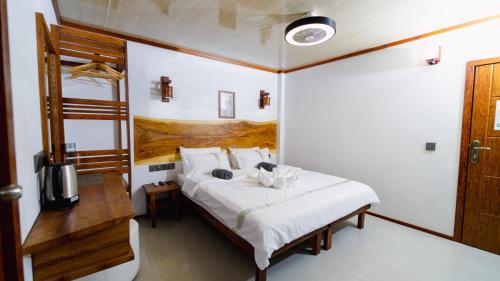 a bedroom with a bed in a room at Turtle Hive - Velaa Vani in Dhiffushi