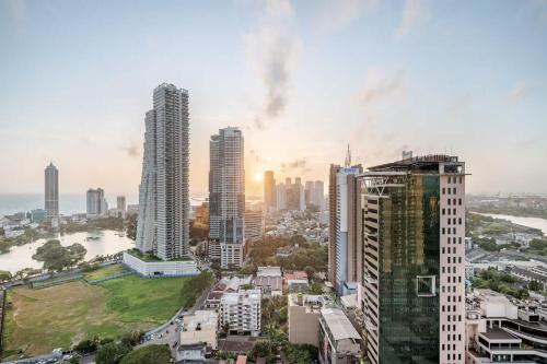 a city skyline with tall buildings in the foreground at Luxury 2 Bed at Trizen by Resident Villas in Colombo