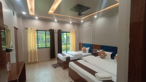 Postel nebo postele na pokoji v ubytování Rajbari Resort
