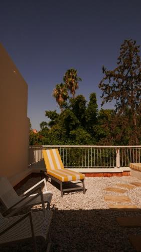 a yellow and white chair sitting on a patio at MORO Marrakech Boutique Hôtel in Marrakech