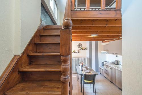 a staircase leading up to a kitchen with a table and chairs at Step Inn Kastoria in Kastoria
