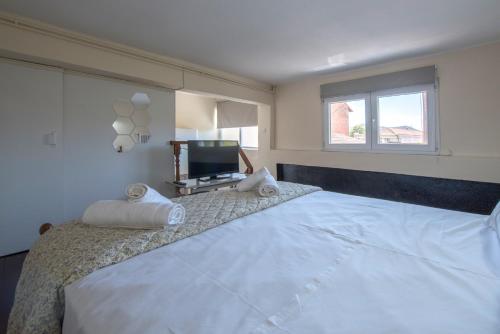 a bedroom with a large bed with a flat screen tv at Step Inn Kastoria in Kastoria