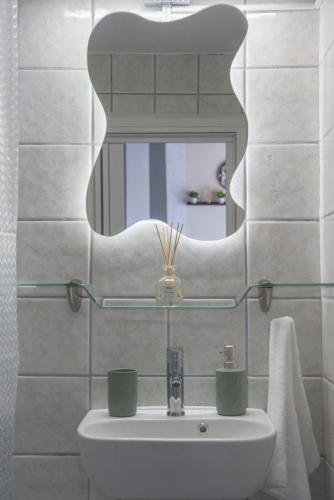 a bathroom with a sink and a mirror at Step Inn Kastoria in Kastoria