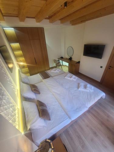 a large white bed with pillows in a room at Sarhad Hotel in Bukhara