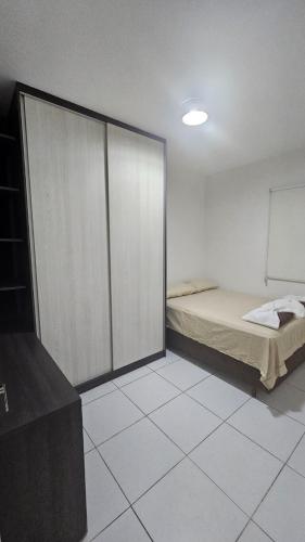a room with a bed and a sliding glass door at Apt conforto e aconchegante prox a Novafapi e ao Shopping Carnauba in Teresina