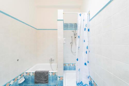 a white bathroom with a shower and a tub at Ca' de Nina, nel cuore di Moneglia a pochi passi dal Mare in Moneglia