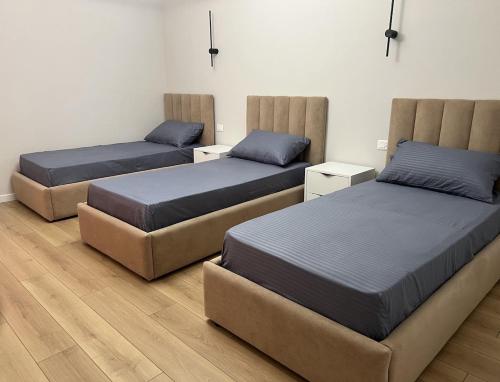 three beds sitting in a room with at Poolside Bliss - Escape & Relax in Kalmet