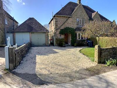 a large house with a fence and a driveway at Silcrest in Baslow