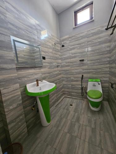 a bathroom with a sink and a toilet at Arhiba Guest House አርሂባ እንግዳ ማረፊያ 