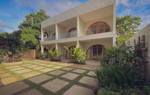 an exterior view of a house with a courtyard at Namal Resort - Free scooter and Gym access in El Nido