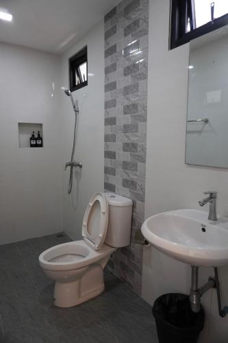 a bathroom with a toilet and a sink at JP Resort Koh Tao in Koh Tao