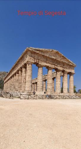 an ancient building with columns in a field at Villa Calatafimi Segesta in Calatafimi
