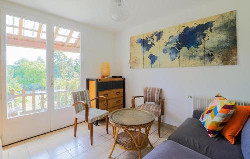 a living room with a couch and a table at Jolie Maison Proche Rivière in Jaulgonne