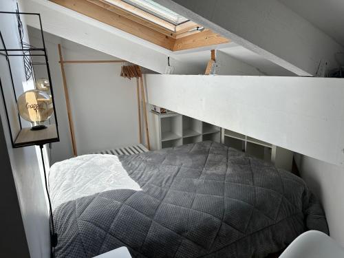 a bed in a small room with a loft at L'Aire des montagnes in Bolquere Pyrenees 2000