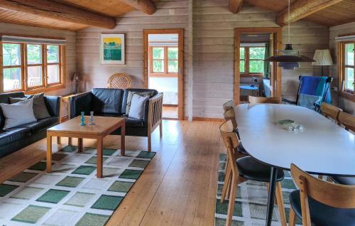 a living room with a couch and a table at Amazing Home In Stege With Kitchen in Stege