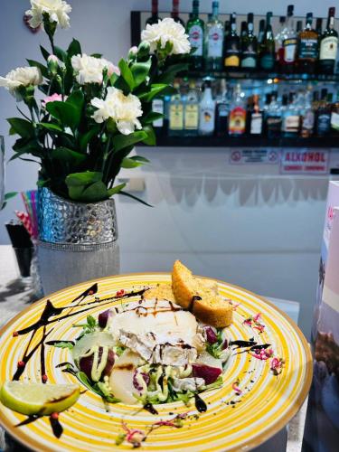 a plate of food on a table with a sandwich and bread at Hotel Sobieszewo in Gdańsk