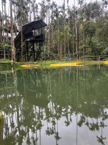 a platform in the middle of a body of water at Haranamakki Homestay in Kalasa
