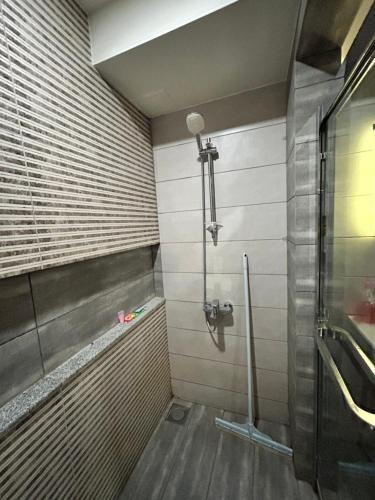 a bathroom with a shower with a glass door at Elysium Serviced Apartments By LMY Blue Area Facing Centaurus Mall Islamabad in Islamabad