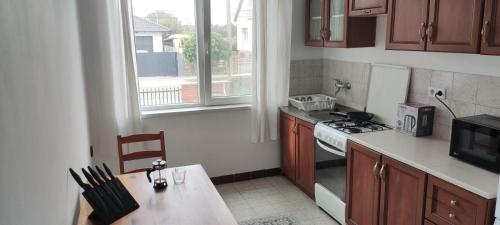 a kitchen with a table and a stove top oven at Mediterran Garden Lil Apartment in Vecsés