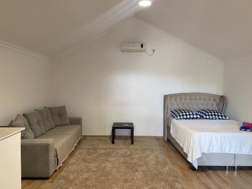 a living room with a bed and a couch at Home in Poti