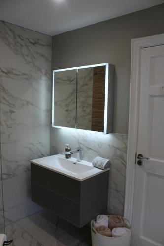 a bathroom with a sink and a mirror at The Fairways, CastleBlayney in Castleblayney