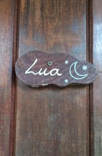 a sign on a wooden door with the name luna at Pousada Cavallitos d'Amar in Ilha de Boipeba