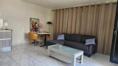 a living room with a couch and a table at The Blue Donkey in Paramaribo