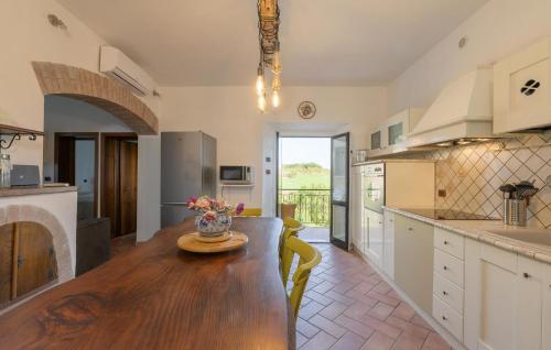 a kitchen with a wooden table and a dining room at Stunning Apartment In Ville Di Corsano in Corsano