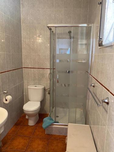 a bathroom with a toilet and a glass shower at Casa Ramona in Valencia