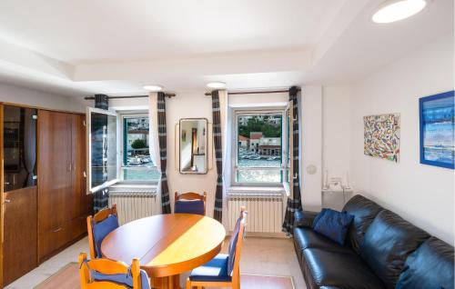 a living room with a table and a couch at Three-Bedroom Apartment In Povlja in Povlja