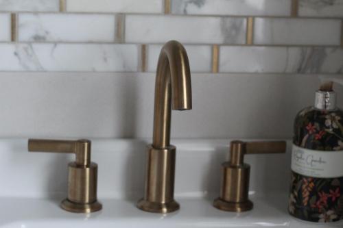 a sink with two faucets and a bottle of soap at The Fairways, CastleBlayney in Castleblayney