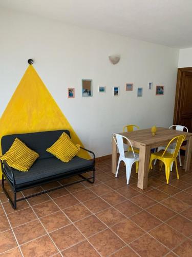 a living room with a couch and a table at Sa Domo De Lory in Torpè