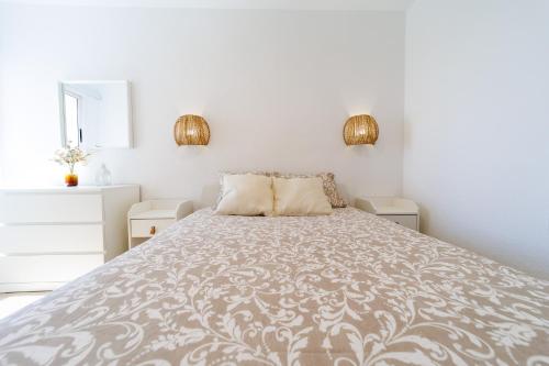 a bedroom with a bed and two night stands at Guanabara Sunset in Puerto Rico de Gran Canaria