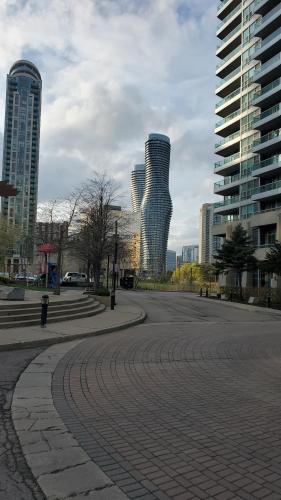 a cobblestone street in a city with tall buildings at Lovely 1 bedroom Condo Downtown Mississauga Square One in Mississauga