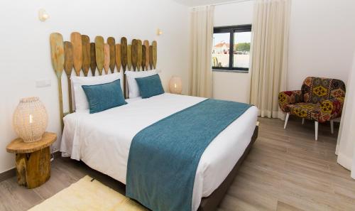 Ένα ή περισσότερα κρεβάτια σε δωμάτιο στο Mareta Beach House - Boutique Residence