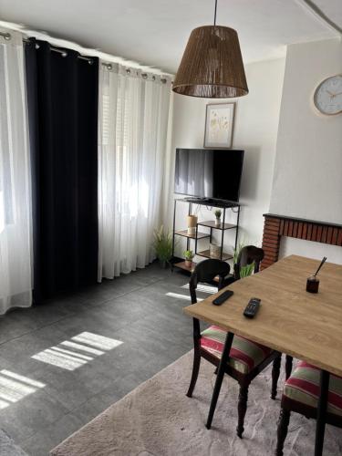 Gîte Vauban في سانت-أومير: غرفة معيشة بها طاولة وكراسي خشبية