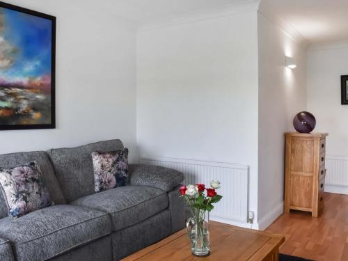 a living room with a couch and a table at Dunlin Haven in Sandside