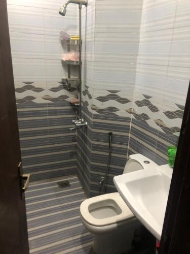 a bathroom with a toilet and a sink at Twilight Moon in Lahore