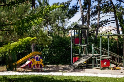 a playground with a slide in a park at Casa da Lua in Ericeira