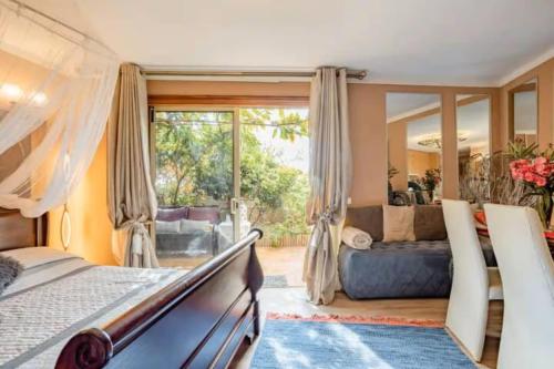 a bedroom with a bed and a living room at Kordelliya Garden Apartment in Chayofa