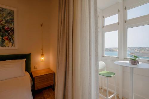 Postel nebo postele na pokoji v ubytování V60 Valletta