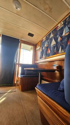 a room with a bed and chairs in a boat at Lisbon Boat Speedboat G44 in Lisbon