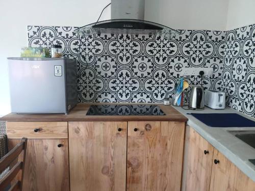a kitchen with a black and white patterned wall at Serene Mountain Retreat in KL - Entire House for Rent in Kampong Kelang Gates Baharu