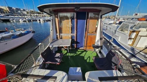 a boat docked in a marina with chairs on it at Lisbon Boat Speedboat G44 in Lisbon