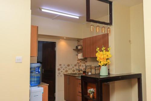 a kitchen with a counter with a vase of flowers on it at Royal Homes in Nairobi